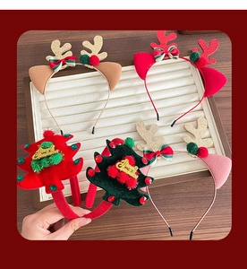 Detail showing plush reindeer antlers and Christmas tree headbands with Merry Christmas text