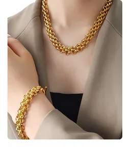 Detailed view of chunky gold-plated chain necklace and bracelet set with T-bar toggle clasp