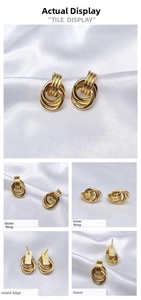 Detailed macro view of triple interlocking gold hoop earrings with textured metal finish