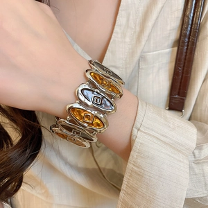 Detailed macro view of vintage wide stretch bracelet with amber oval resin and silver metal