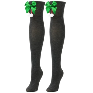 Detail of dark grey over-knee knitted socks with green satin bows and white pompoms