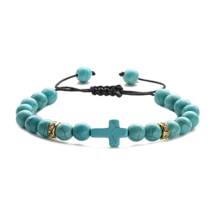 Adjustable braided rope bracelet with turquoise cross beads and gold accents on white base