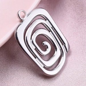 Macro shot of silver 304 stainless steel square pendant with spiral cutout detail