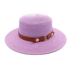 Macro detail of lavender straw boater hat with brown leather band and gold buckle
