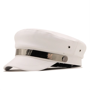 White faux leather baker boy hat featuring a metallic band and M logo detail