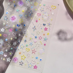 Detail of embossed metallic star and heart nail stickers with colorful gradient effect