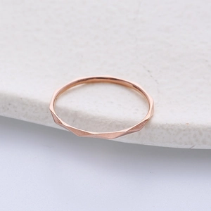 Minimalist rose gold stainless steel ring with faceted geometric diamond cut design