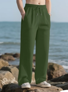 Close-up of military green textured wide-leg trousers with drawstring elastic waistband