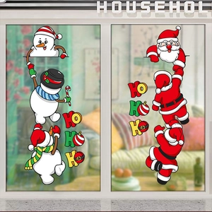 Detail of Christmas window stickers with cartoon Santas and snowmen on glass