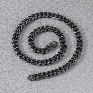 Close-up of a thick black stainless steel Cuban link necklace with a secure lobster clasp