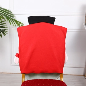 Red Santa Claus chair back cover with black collar on a wooden dining room chair