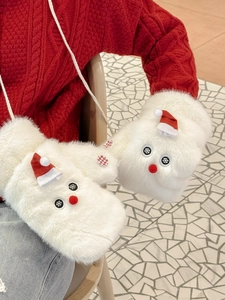 Detail of white plush mittens featuring red Santa hats and cute snowman decorations