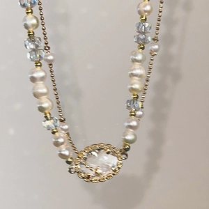 Elegant oval crystal and pearl necklace with faceted stones and golden beads