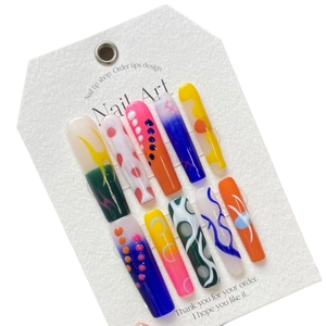 Handmade press-on nails with colorful pop art patterns in long coffin shape