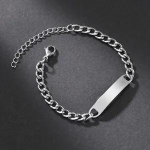 Detailed view of silver stainless steel Cuban chain bracelet with smooth rectangle ID tag