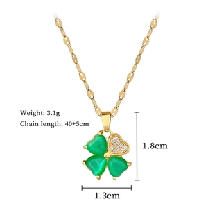 Detail view of gold clover necklace with green stones and precise size measurements