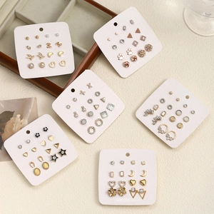 Flat lay of 6 sets of stainless steel stud earrings featuring pearls and rhinestones