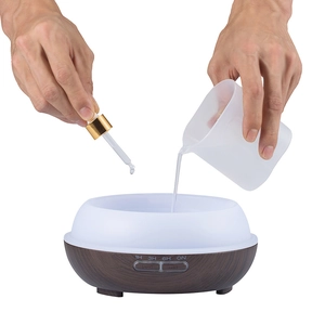 Close-up of adding water and essential oil into the wood grain aroma diffuser base