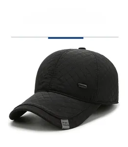 Detail of black quilted baseball cap with ear flaps and Sport Fashion label on the brim
