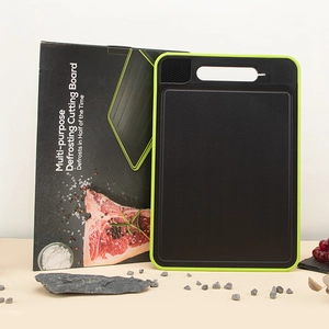 Multi-purpose defrosting cutting board with green border shown with fresh ingredients