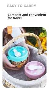 Portable yogurt breakfast cup with lid and folding spoon inside a picnic basket
