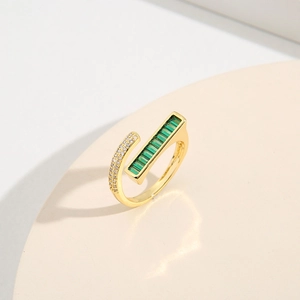 Elegant gold open ring with emerald-cut green gemstone and pave-set white cubic zirconia