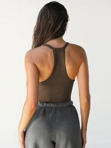 Close-up of brown ribbed knit texture and fit on a woman's slim-fit vest top
