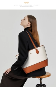 Detail of a large capacity color-block tote bag in beige and brown leather