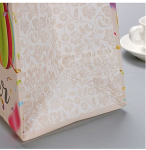 Close-up of durable laminated non-woven fabric and floral print on Easter gift bag