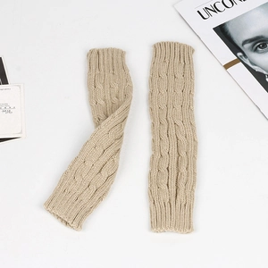 Close-up of beige cable knit arm warmers with soft acrylic texture on white background