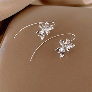 Elegant silver iris flower earrings with textured petals in a minimalist curved hook design