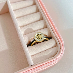 Close-up of three-in-one tree of life ring set with sparkling crystals in jewelry box