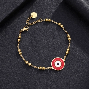 Macro view of golden stainless steel evil eye bead bracelet with lobster clasp detail