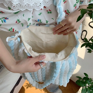 Detailed interior of blue and white bubble texture tote bag with inner pocket