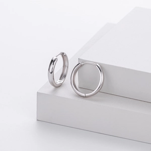 Detailed macro view of S925 sterling silver hollow hoop earrings showing 925 hallmarks