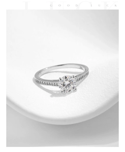 Close-up of S925 sterling silver ring with one carat round moissanite and side stones