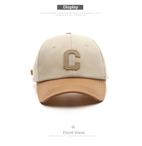Detail of two-tone cotton baseball cap with khaki brim and embroidered letter C patch
