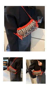Chic leopard print underarm bag with red leather strap shown on a black blazer