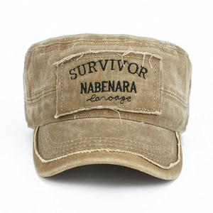 Detail of distressed brown cotton cadet cap with vintage survivor embroidery and frayed edges