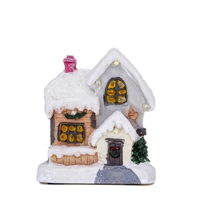 Macro detail of Christmas snow house decoration with LED lights and wreath textures