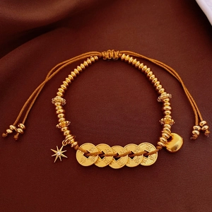 Detail of 18k gold plated bracelet with cat eye stone on luxury silk fabric