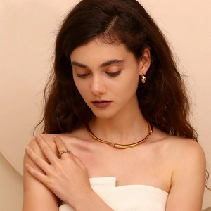 Close-up of minimalist gold plated necklace, earrings and pearl ring jewelry set