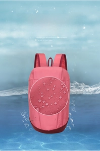 Close-up of pink waterproof sport backpack fabric showing water-repellent droplet effect