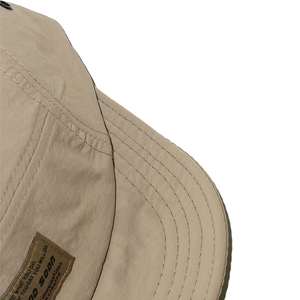 Macro shot of khaki nylon fabric texture and parallel reinforced stitching on brim