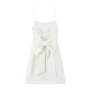 Detail of a large decorative bow on the back of a white sleeveless mini dress