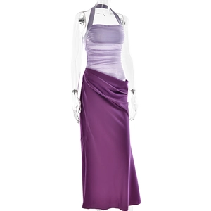 Detailed view of the purple halter-neck pleated mesh top and drape skirt on a mannequin