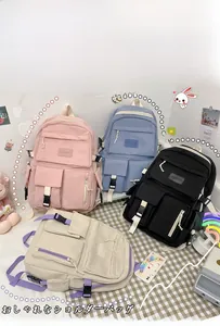 Flat lay of colorful nylon backpacks in pink, blue, black, and beige with multi-pockets