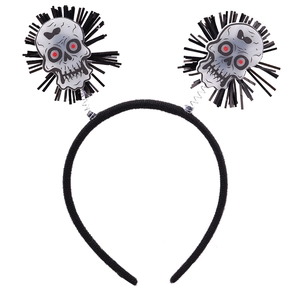 Detail of Halloween headband with black feathers and spring-mounted skull ornaments