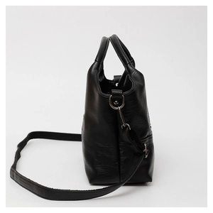 Detail of soft black leather texture and metal buckle on women's commuter handbag