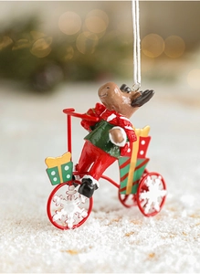 Detail of reindeer on bicycle ornament with snowflake wheels and gifts on snowy background